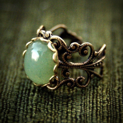 Antiqued brass adjustable mod vintage-inspired filigree ring with a green aventurine semi-precious stone mineral in the bloomcore aesthetic