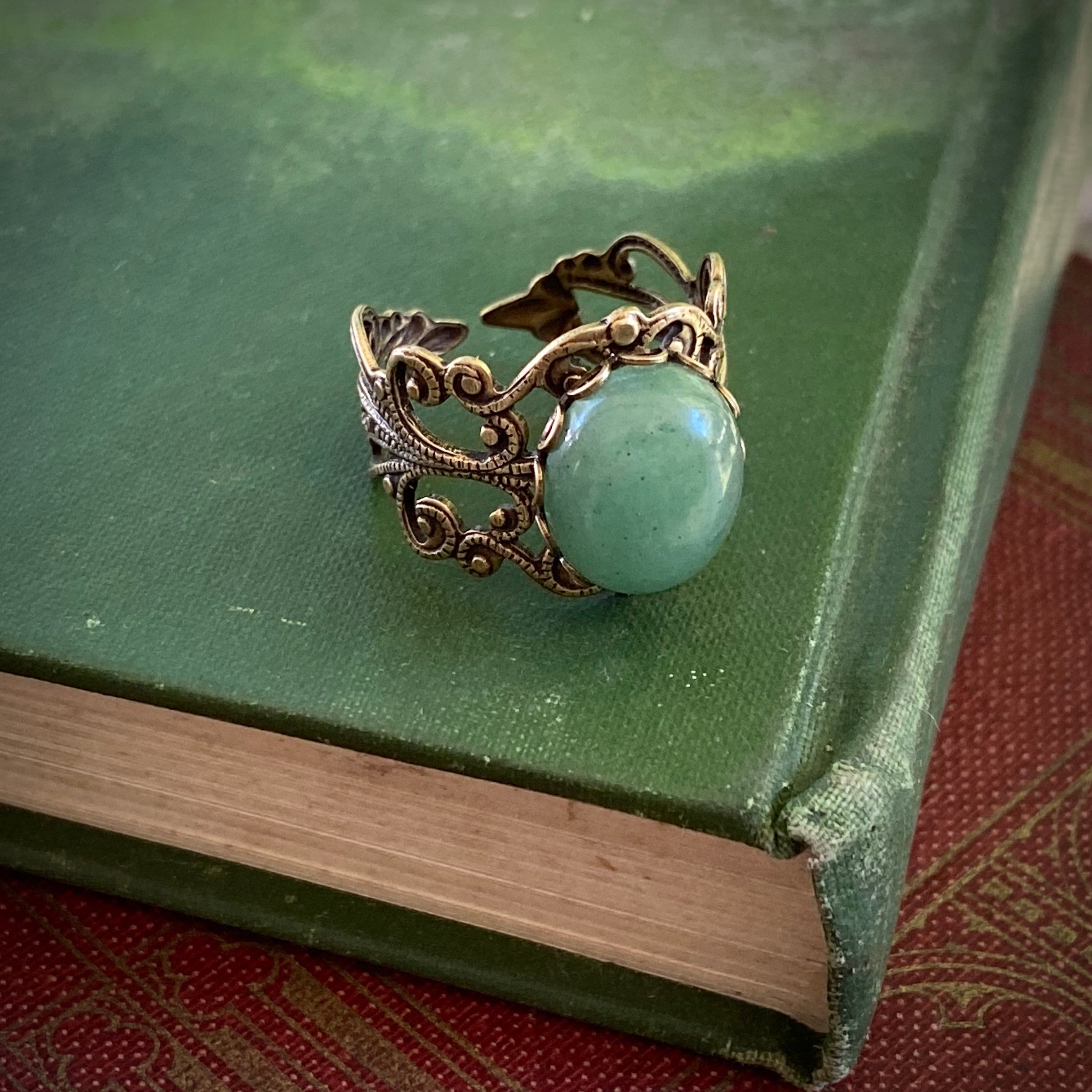 Antiqued brass adjustable vintage-inspired filigree ring with a green aventurine semi-precious stone mineral in the cottagecore aesthetic