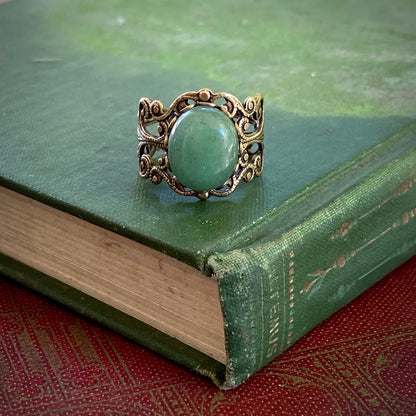 Antiqued brass adjustable mod vintage-inspired filigree ring with a green aventurine semi-precious stone mineral in the witchy academia aesthetic